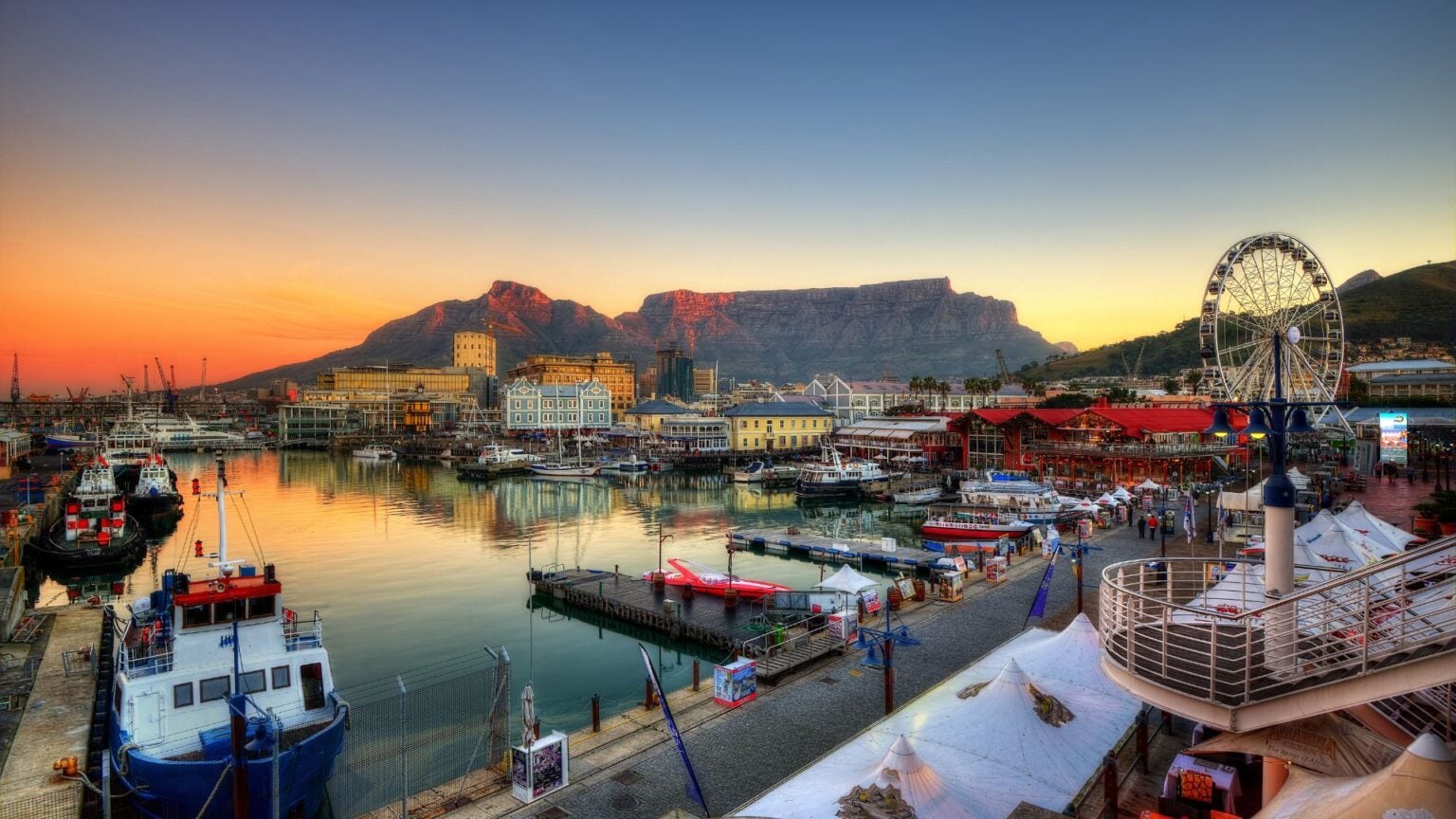 Photo of Port in South Africa with boats on the harbor and a ferris wheel far away on the right