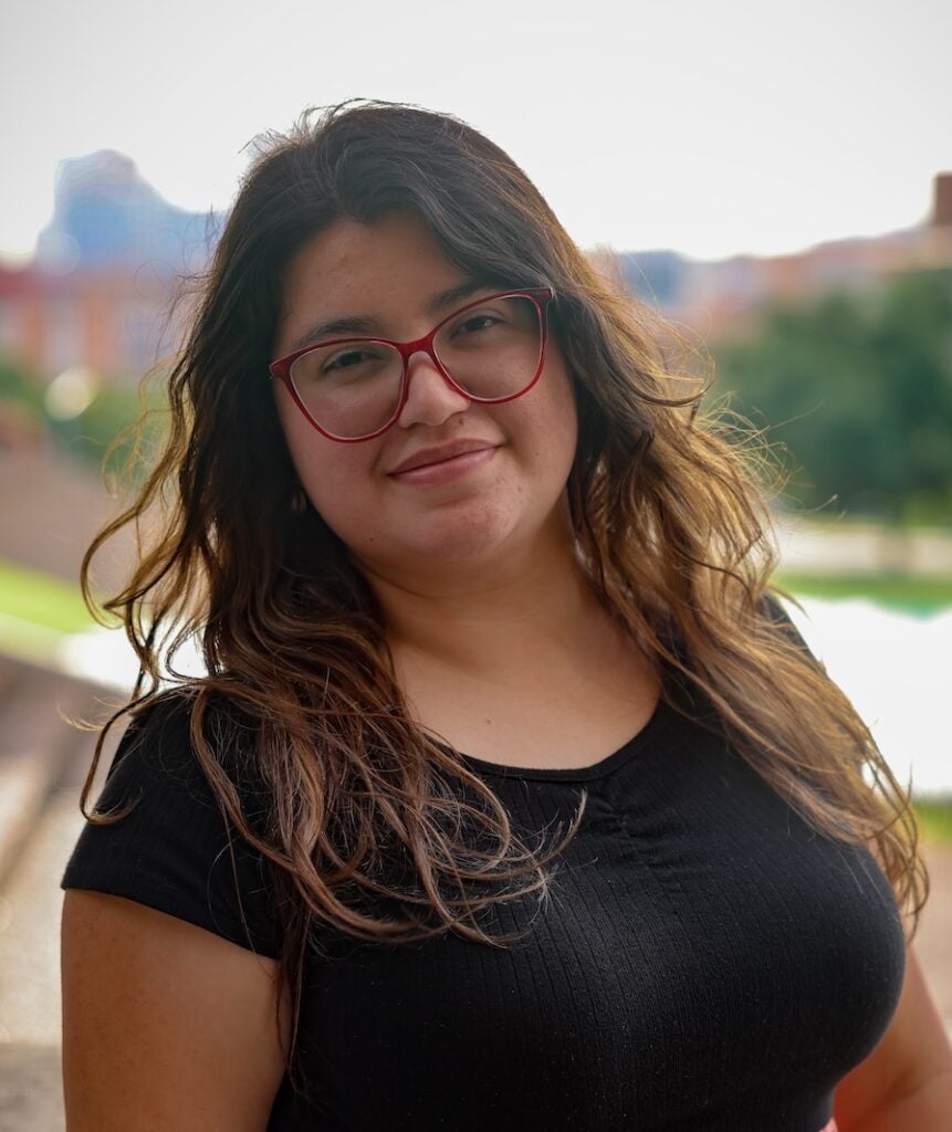 Person with long hair and glasses