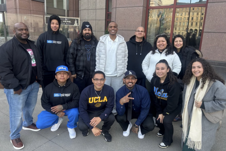 Group of men and women outside building