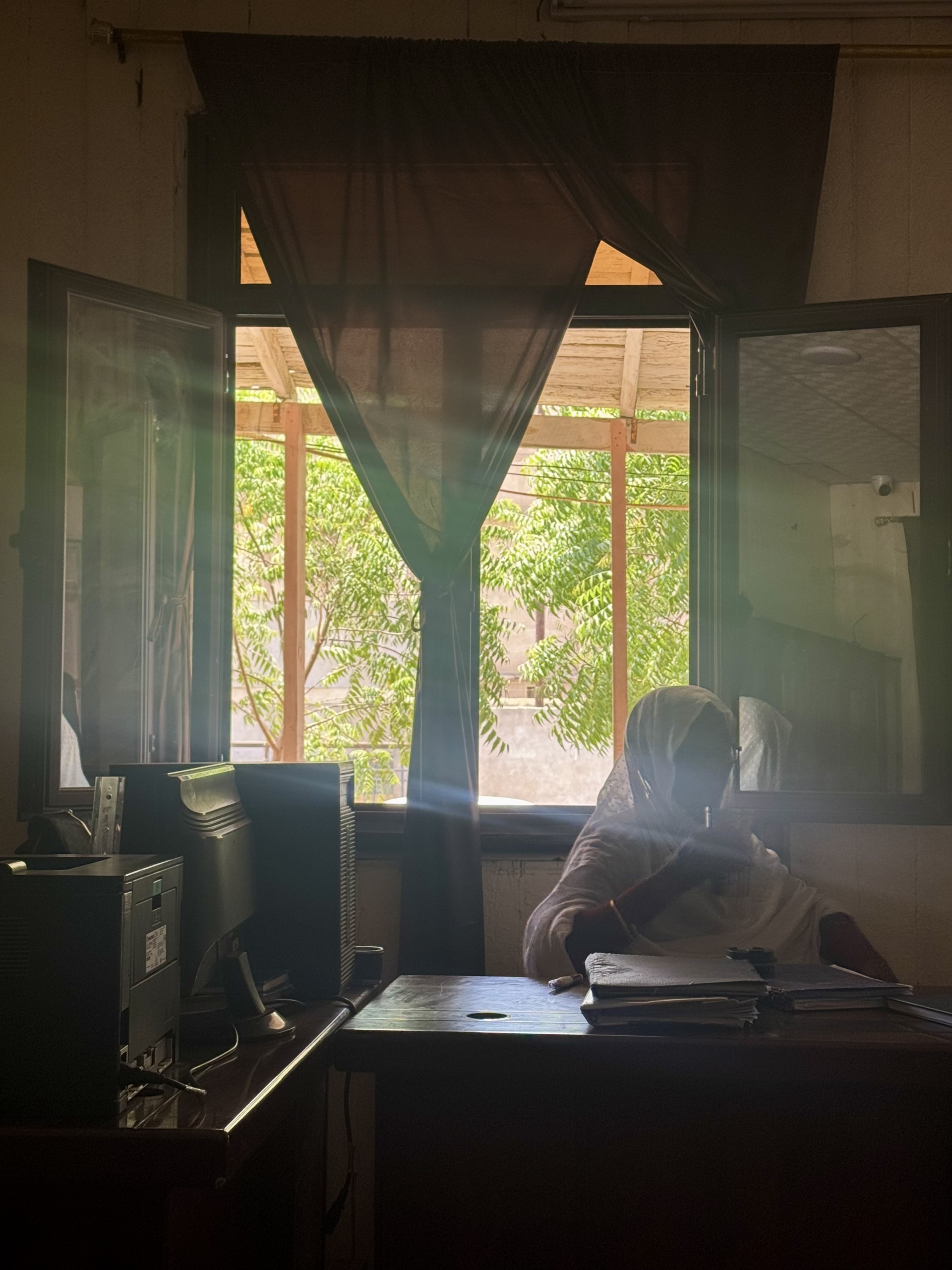 Photo of student Muram Ibrahim in front of a window
