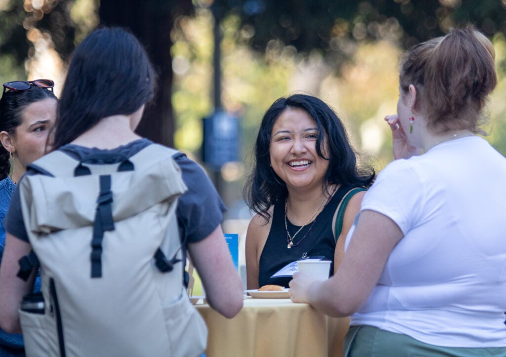 Student smiles at classmates during Luskin Graduate Student Orientation 2025.