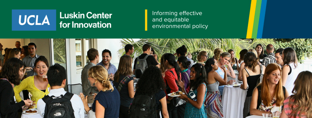 A crowded outdoor reception shows attendees mingling, talking, and holding plates of food near palm trees and draped cocktail tables.