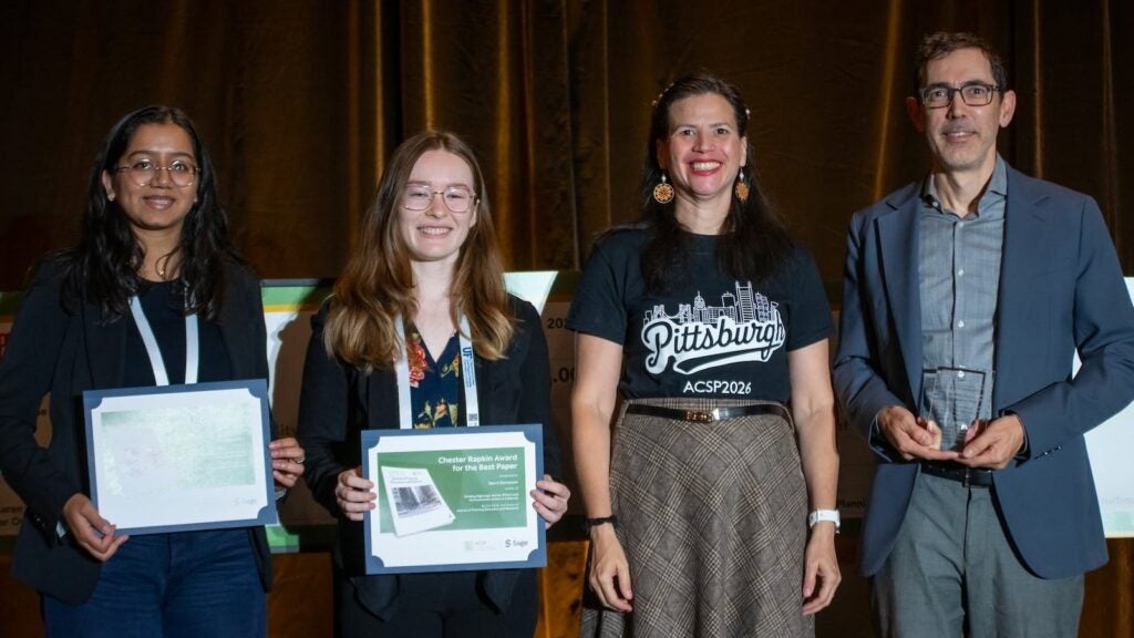 four people on stage holding awards
