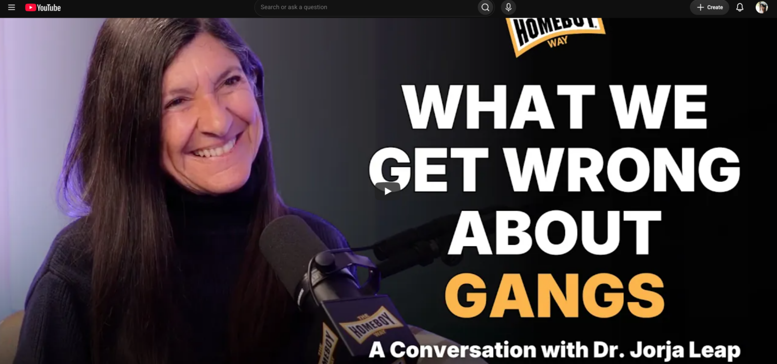 Photo of Jorja Leap professor of social work smiling on the left with "What we get wrong about gangs" on the right which is the thumbnail for the podcast episode