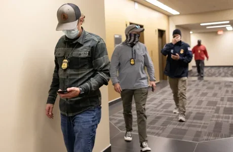 ICE agents arrive outside of a courtroom to detain someone at Seattle Immigration Court in June in downtown Seattle. Data shows immigration enforcement has indeed scaled up in Washington. Arrests have climbed, most sharply in June, but not as much as they have nationwide. Most of those arrested in Washington and nationwide do not have a criminal record. (Nick Wagner / The Seattle Times)