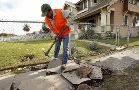 file photo of a broken sidewalk under repair