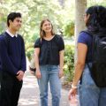 Three students stand in the Sculpture Garden at UCLA speaking to each other