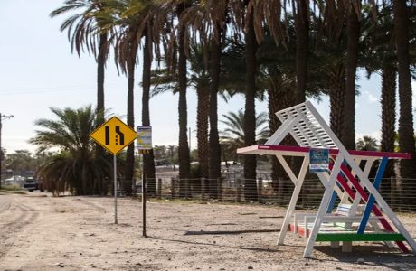 A shade structure is built around a bus stop