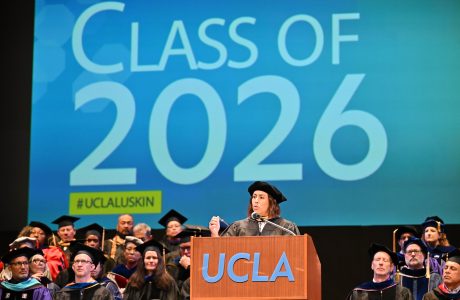 Caroline Menjivar speaks on stage at UCLA Luskin Commencement ceremonies on June 12, 2026. She is a California State Senator and a prominent alumna of the UCLA Luskin School of Public Affairs, having earned her Master of Social Welfare (MSW) in 2018.|Jacqueline Waggoner '18 on the stage in front of a podium giving her commencement speech to the undergraduate class of 2026.