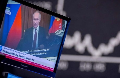 Russia's President Vladimir Putin appears on a television screen at the stock market in Frankfurt, Germany