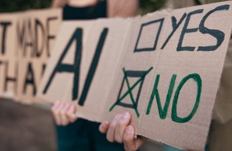 protest signs in opposition to artificial intelligence