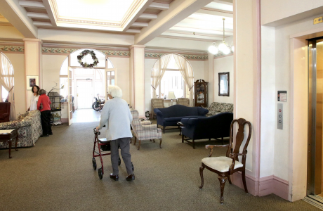 woman with a walker in a lobby