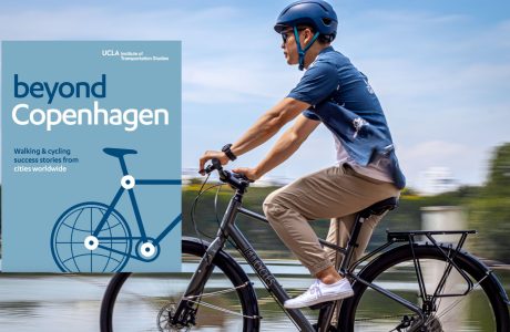 A man with a helmet riding a bicycle, motion shot with the cover of the journal yond Copenhagen: Walking & cycling success stories from cities worldwide on the left overlay the photograph