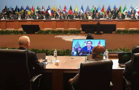 delegats at conference tables with international flags