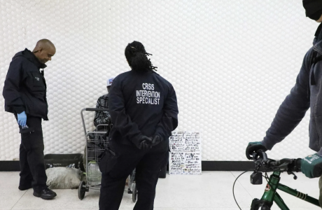 Civilian officers in black jackets in transit station