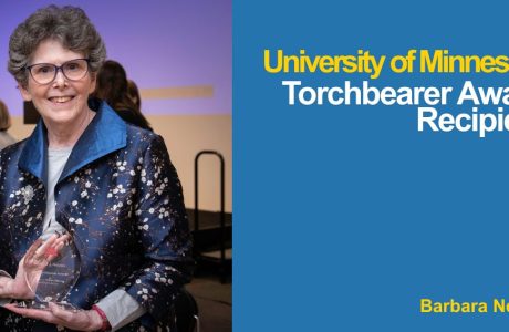 Photo of Barbara Nelson holding her Torchbearer Award at the ceremony|