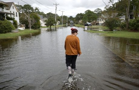 woman walking through flooded street