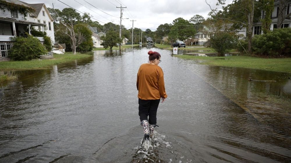 woman walking through flooded street