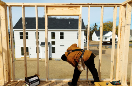 worker building home in back yard