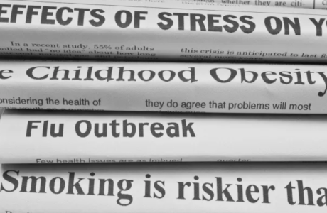 stack of newspapers with headlines on health issues