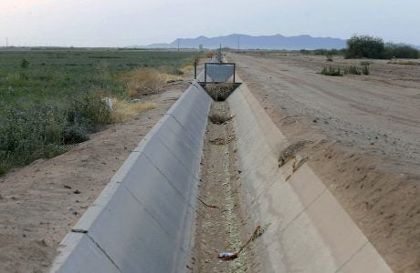 dry irrigation canal near farmland