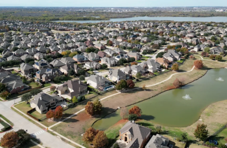overhead shot of housing development near manmade lakes