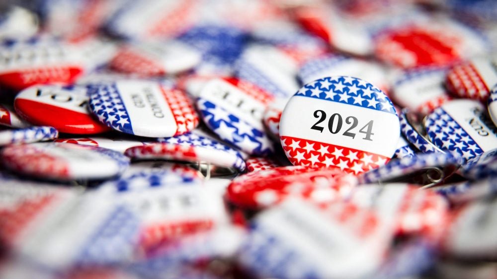 red, white and blue election buttons emblazoned with "2024"