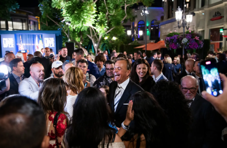 Man in suit in crowded outdoor venue