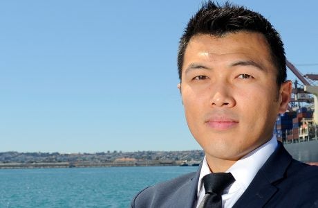 closeup photo of man standing outside near a body of water