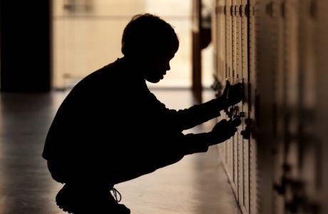 Child opening locker at school