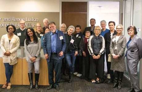 group photo of about 15 people who attended the dean's associates gathering|portrait of woman with glasses and light-colored hair|portrait image|portrait images of three men