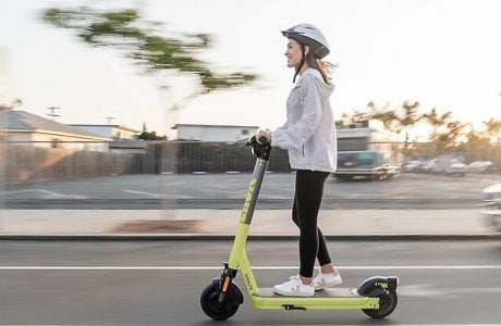stock image shows a young woman on a scooter
