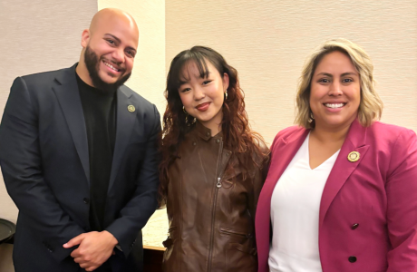 three people|two young women at podium