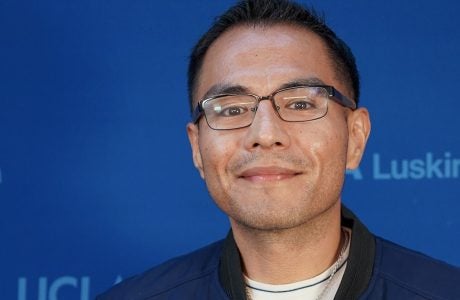 Man with short dark hair and glasses