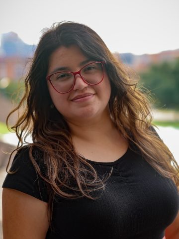 Person with long hair and glasses