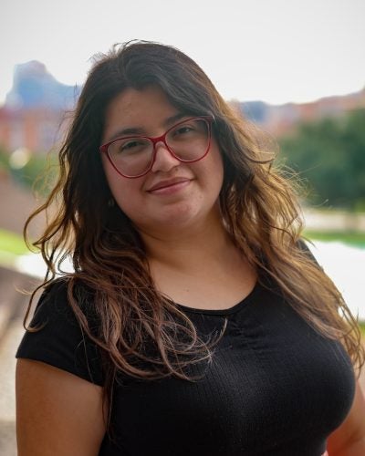 Person with long hair and glasses