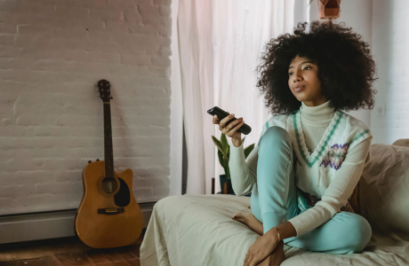 woman on couch with remote