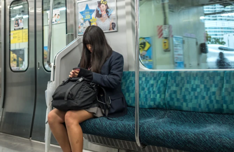 young woman sitting alone on subway