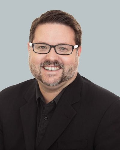GregMorrow-headshot_gray_orientation-1-1