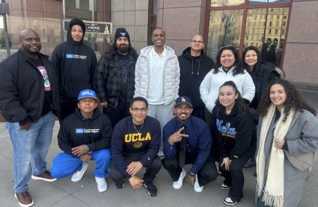 Group of men and women outside building