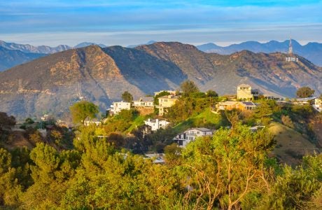 hollywood hills with homes and mansions, mountains in the background and the Hollywood sign