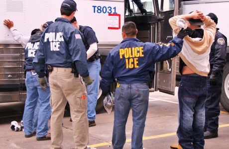 Photo of ICE agents making an arrest.