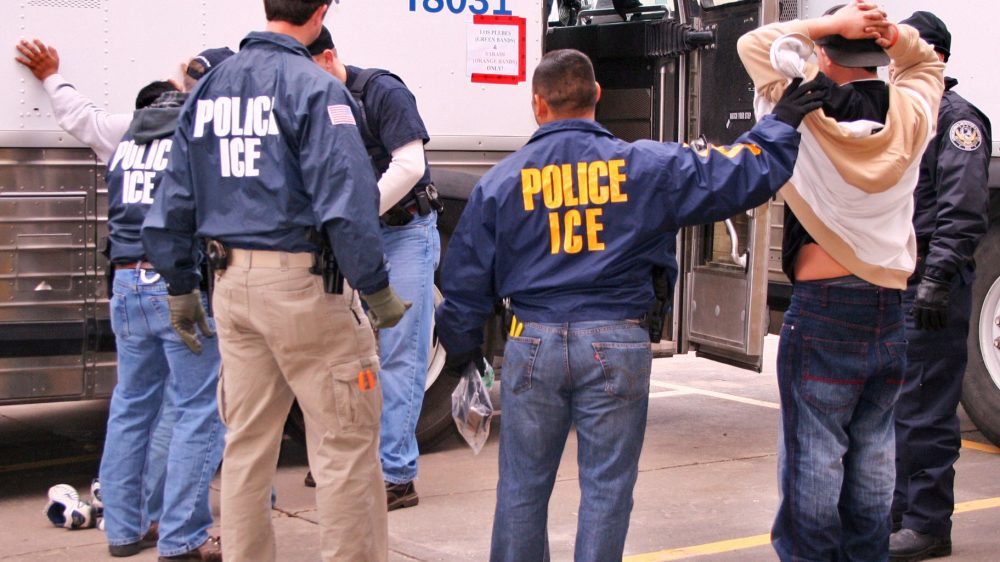 Photo of ICE agents making an arrest.