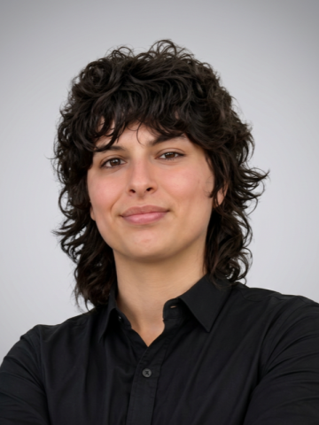 person with dark hair in black shirt