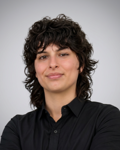 person with dark hair in black shirt