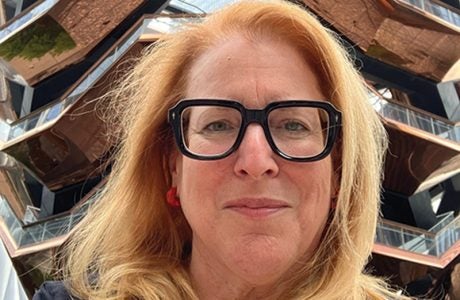 portrait of woman with glasses and light-colored hair