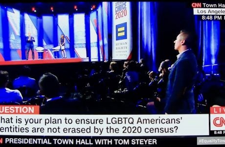 Kevin Medina of the UCLA Luskin undergraduate program's staff poses a question to candidate Tom Steyer.