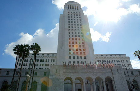 Tall white building set against blue sky