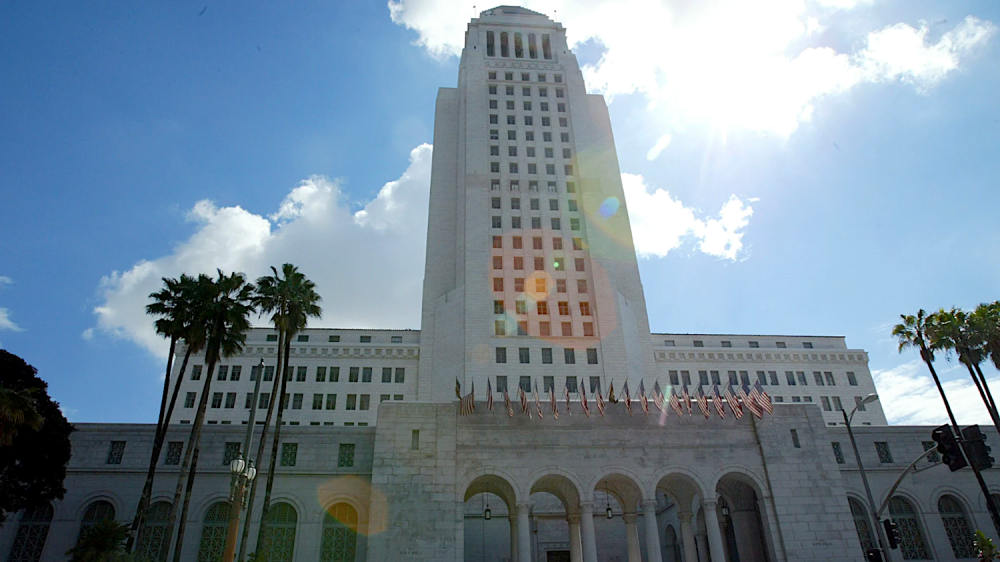 Tall white building set against blue sky