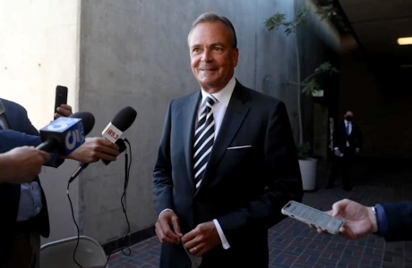 Man in suit being interviewed.